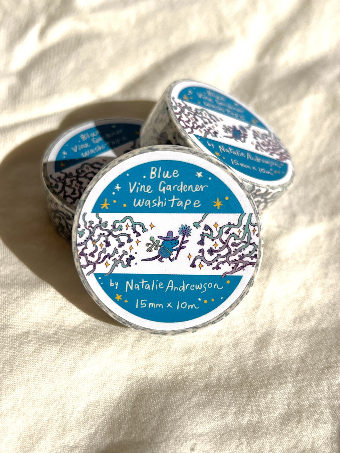 This washi tape features three little blue gardeners who work to keep the vines at bay.

This roll is 15mm wide x 10m of paper tape. Washi tape is super durable and flexible. It tears easily and can be safely applied to a variety of surfaces; it doesn’t leave a sticky residue behind, making it especially ideal for stationery and hanging prints temporarily.