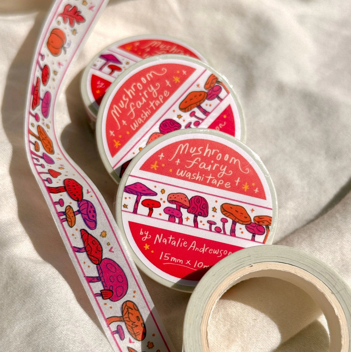 This washi tape features little mushrooms in pinks, reds, and oranges all lined up one after another. This tape design is taken from my Mushroom Fairy print's decorative borders.