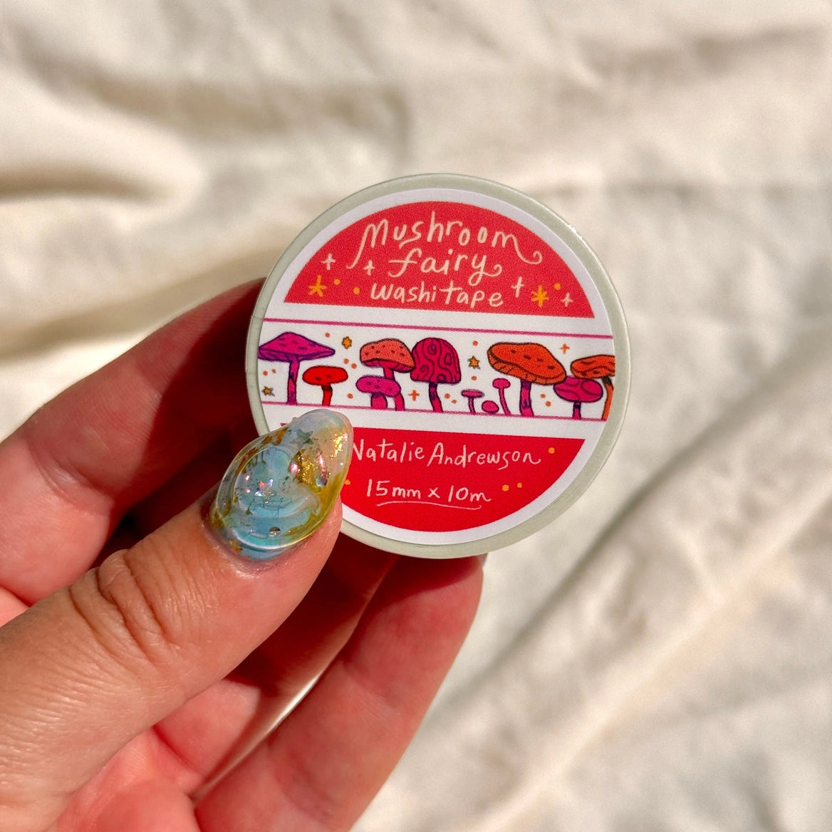 This washi tape features little mushrooms in pinks, reds, and oranges all lined up one after another. This tape design is taken from my Mushroom Fairy print's decorative borders.