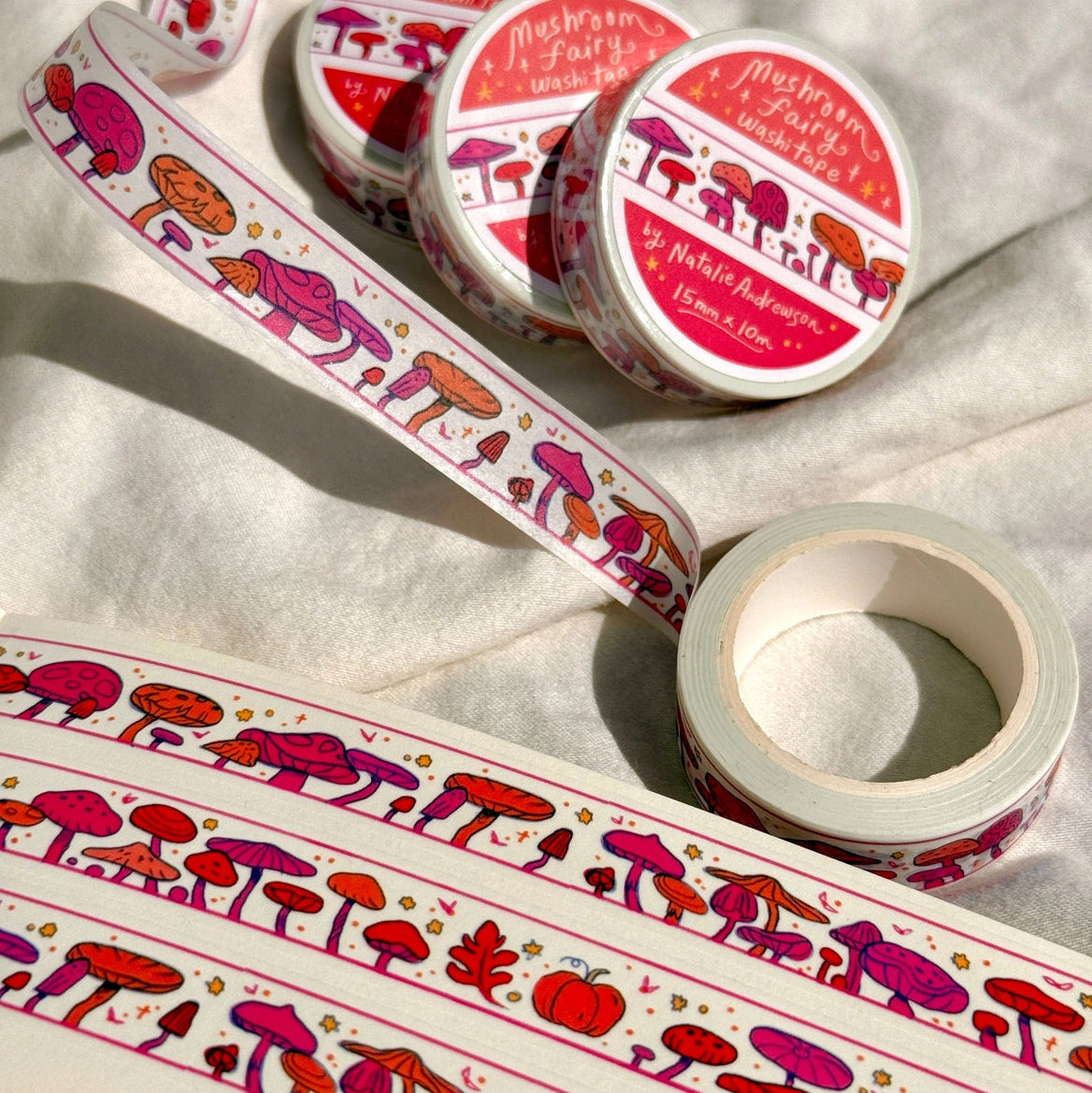 This washi tape features little mushrooms in pinks, reds, and oranges all lined up one after another. This tape design is taken from my Mushroom Fairy print's decorative borders.