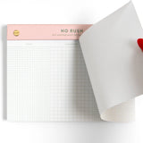 Meet your new favorite procrastination tool—the No Rush Notepad! This 6x8” desk pad is perfect for loosely organized to-do lists with sections for Today, Tomorrow, and… Never. With 75 perforated grid sheets on smooth 120gsm paper, plus a luxe gold post-bound top, it’s equal parts practical and playful. Whether you’re tackling tasks or artfully avoiding them, this notepad keeps everything in sight—just not necessarily on schedule. Ideal for office desks, student planners, or anyone with a sense of humor abou