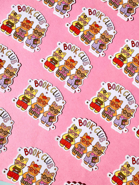 These adorable book themed stickers are perfect for sharing with your book club friends. It features 3 adorable cats with their favorite reads!

These matte vinyl stickers feature an original design and are water, weather, and scratch proof. Perfect for putting on water bottles, computers or just about anywhere else.