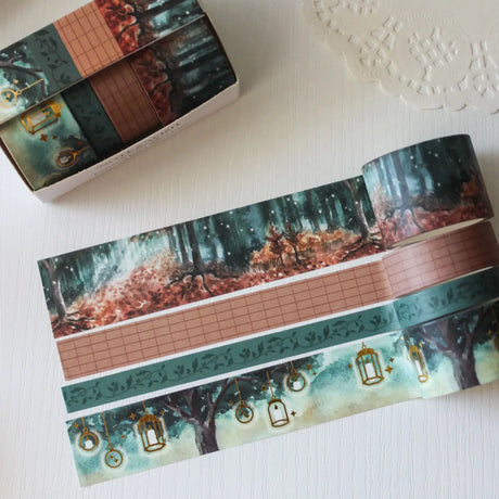 This enchanted forest washi tape gift set is designed for dreamers, storytellers, and stationery lovers who enjoy woodland walks at dusk. Featuring hand-painted watercolour forest scenes by Rebecca. Perfect for journaling and anyone who loves bringing the beauty of the British countryside into their creative projects.

30mm x 5m - Forrest
25mm x 5m with gold foil - Lanterns
5mm x 5m - Foliage
10mm x 5m - grid