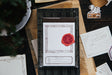 OURS Studio Wooden Frame Letterpress Label Book Decorative paper with a red wax seal on a wooden surface with stationery items.