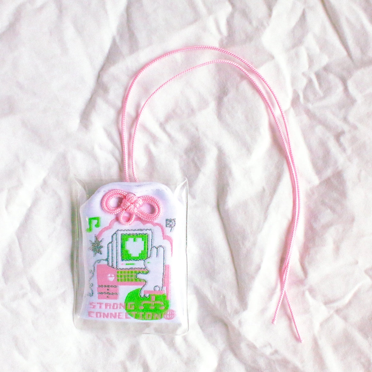 2x2.5 omamori charm with a 8 inch string.

An omamori is a Japanese charm that provides protection and luck!