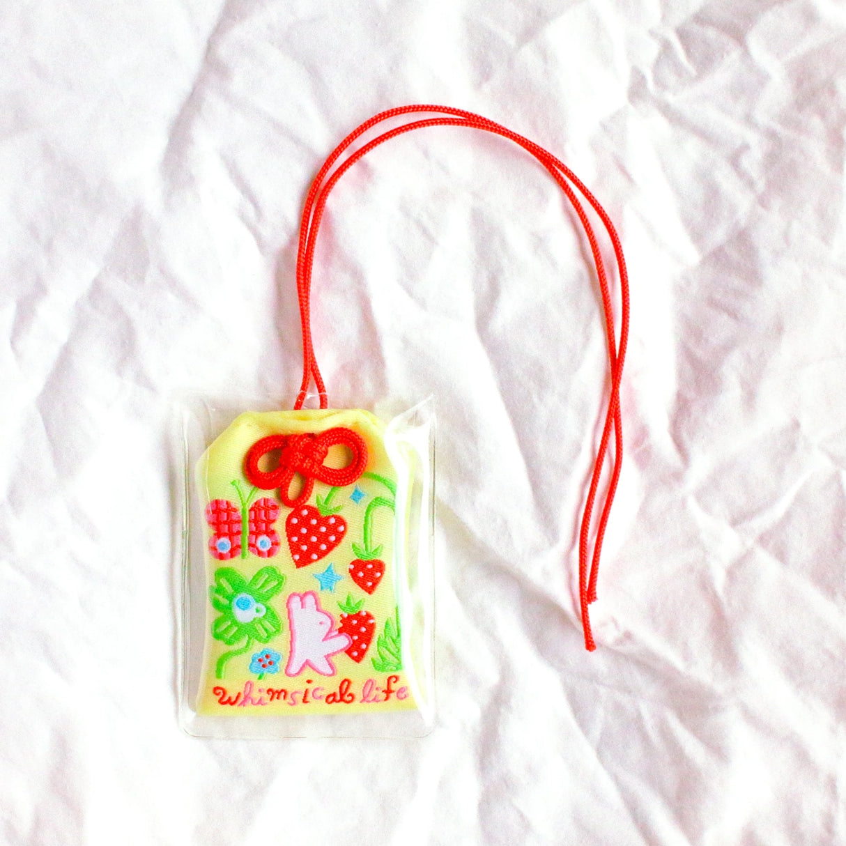 2x2.5 omamori charm with a 8 inch string.

An omamori is a Japanese charm that provides protection and luck!