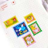 'Love Letter' Frosted Glitter A6 Sticker Sheet.

Not waterproof.
Do not place in areas of high wear (laptops, phone cases, water bottles, etc).
Stickers come in a plastic sleeve.