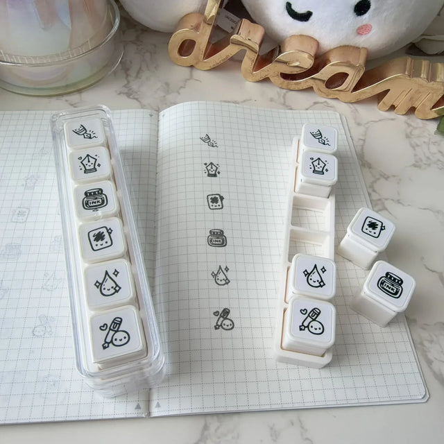 Once More With Love 6 in 1 Punch Stamp - Fountain Pen Lovers

6-in-1 removable stamps for Fountain Pen Lovers!

Can be used right in the bracket or taken out for more precise stamping. The stamps are self-inking and come in a transparent case!

***IMPORTANT:&nbsp;Stamps come very well inked. Make sure you use scrap paper to stamp off excess ink prior to using in your notebooks

STAMP SET SIZE:&nbsp;10.75cm&nbsp;(L) x 2.5cm (W) x 2.75cm (H)
INDIVIDUAL STAMP SIZE:&nbsp;1.5cm x 1.5cm
INK COLOUR:&nbsp;Black (re