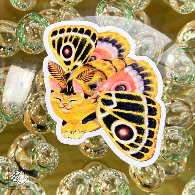 “Vivid Joy” is a colorful and patterned moth from the Moth Cat series.

Moth Cats are a curious and captivating species. The colorful and detailed illustrations are original paintings on birch wood panels.

+ size: 1.7 x 2.3"
+ permanent adhesive glossy vinyl sticker with solid peel backing
+ scratch and weather resistant material, PVC free
+ packaged and shipped flat

All work and photos ©PAPER PUFFIN Art by K.CARLSON