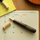 A wooden baseball bat pen by Penco. The bat handle acts as the cap, and the pen tip is made of brass.

Comes in black oil-based ink with 0.8mm tip.&nbsp;