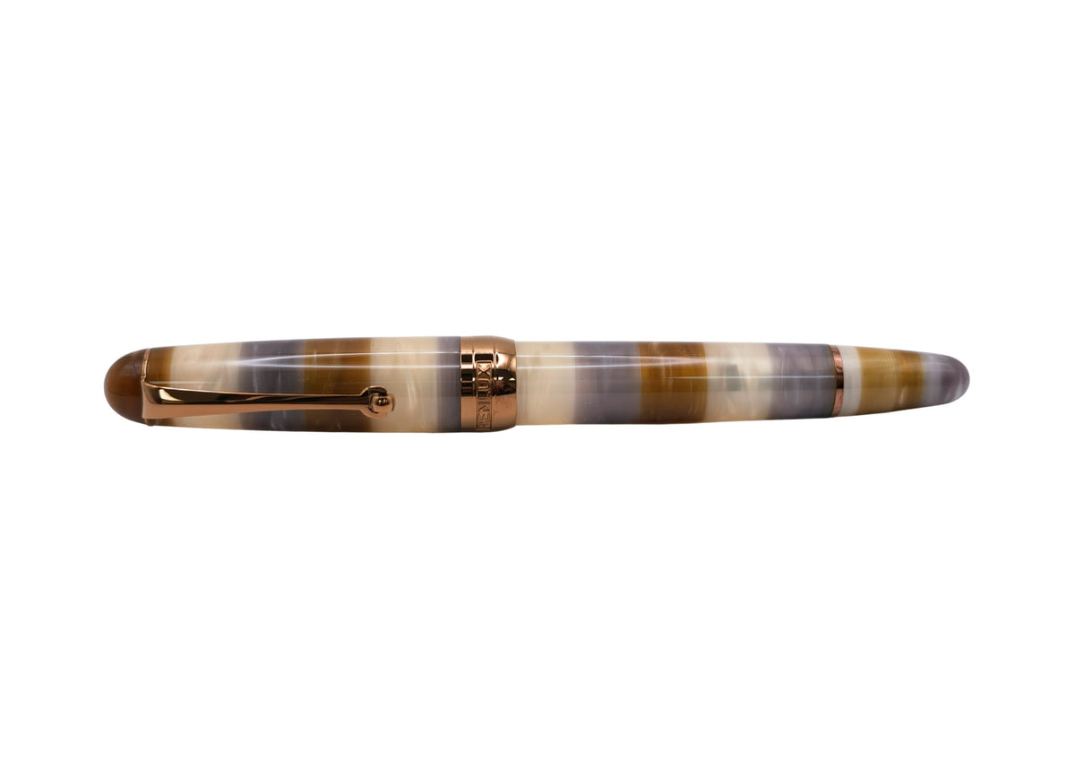 Penlux Masterpiece Delgado Bumblebee Fountain Pen

The collection of Delgado Selected is a premiere version of the Delgado which uses only rare materials and with small production quantity.&nbsp; The Bumblebee was created using PMMA resin and only 70 pieces were produced.&nbsp;

The Bumblebee Delgado features an earthy style with&nbsp;banded swirls of smoky slate grey, translucent honey amber, creamy white, and deep caramel. Topped off with copper plated trim and nib, it looks less like a bug and more like 