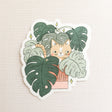 A curious cat settles among lush monstera leaves, tucked into the calm greenery of a Wildflower Woods cottage. This vinyl sticker captures that cozy, plant-filled moment, bringing a touch of quiet charm to your everyday essentials.

Made from durable, waterproof vinyl, this sticker is designed to hold up wherever you place it—whether that’s a water bottle, laptop, or journal you reach for daily.