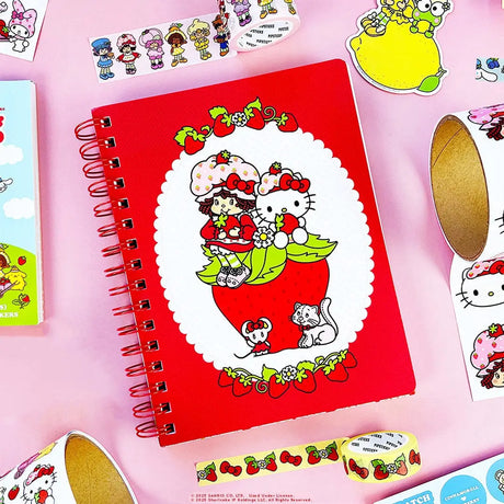 A tiny notebook with major main character energy 🍓💌 Covered in the sweetest strawberry + Hello Kitty details, it’s perfect for quick notes, doodles, and lists you’ll actually want to write. Small enough to toss anywhere, cute enough to show off everywhere.

A bright red spiral notebook featuring Hello Kitty sitting in a strawberry, framed with a white scalloped oval and tiny floral details 🍓 The smooth cover pops with bold color, while inside you’ll find lined pages with coordinating strawberry accents a