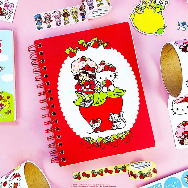 A tiny notebook with major main character energy 🍓💌 Covered in the sweetest strawberry + Hello Kitty details, it’s perfect for quick notes, doodles, and lists you’ll actually want to write. Small enough to toss anywhere, cute enough to show off everywhere.

A bright red spiral notebook featuring Hello Kitty sitting in a strawberry, framed with a white scalloped oval and tiny floral details 🍓 The smooth cover pops with bold color, while inside you’ll find lined pages with coordinating strawberry accents a