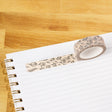 Pressed Floral Washi Tape

Our washi tape is made for paper lovers, pen pals, and anyone who gets butterflies in the stationery aisle. Perfect for journaling, scrapbooking, decorating envelopes, or adding a personal touch to planners and calendars. It's gentle on paper, easy to tear by hand, and removable without leaving residue, so you can rearrange, redo, and re-stick as needed.

Design Features:&nbsp;

Each roll measures 15mm wide on a 10m roll
Full color repeating pattern
Washi tape dispenser packaging
