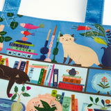 REUSABLE SHOPPING BAG – Our new Purrfect Nook reusable shopping bag features our new puzzle print of the lively, cozy shelfie made for bibliophiles while being stylish and eco-friendly. The bag is also spacious and roomy, with plenty of space to hold all your essentials. It's also lightweight and easy to carry, making it perfect for everyday use. This unique shopping bag is a great way to show off your style while also doing your part for the environment.