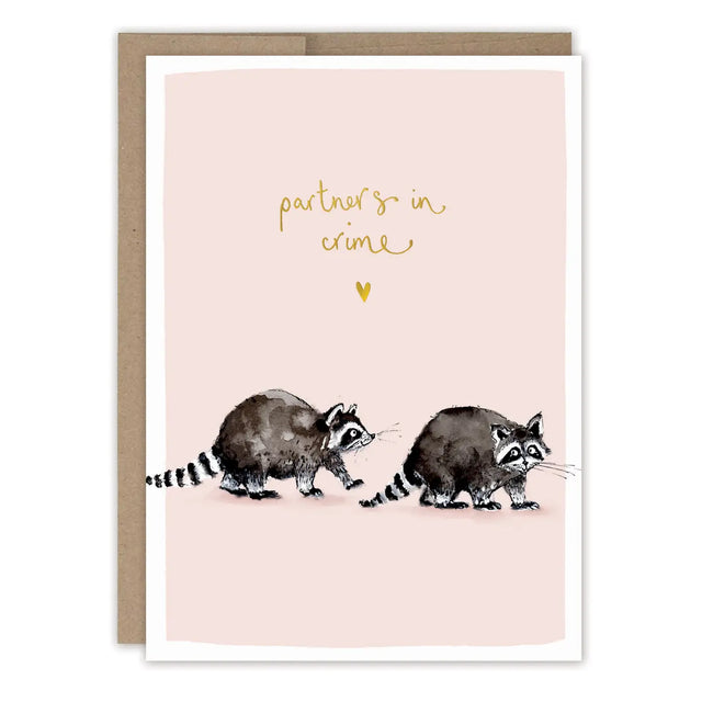 Raccoons Partners in Crime Love Card

Card is blank inside for your own message.

• Size: A6, 4.6" x 6.4"
• Illustrated by Louise Mulgrew
• Treatment: Gold Foil
• Paired with a Brown Kraft envelope
• Printed in the USA on 100% post-consumer recycled paper.

About The Artist: Working with gouache and watercolor, Louise designs in her tiny studio in Brighton, England, inspired by her love of all animals, and passion for the natural world. Louise was named 2023 Artist of the Year by the USA Greeting Card Assoc