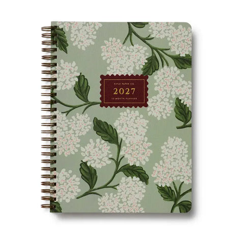 Our softcover spiral planner features a canvas paper cover printed with Hydrangea florals and a gold foil year. Inside you’ll find monthly and weekly views, plenty of space for notes, a list of celebrations, and pockets for storage.&nbsp;

DETAILS

Printed in full color with foil stamped year
Canvas paper cover with white text paper interior
January 2027-December 2027
Monthly and weekly views
Space for notes each week
List of celebrations
Pockets for storage
Spiral bound

6.25" W x 8.5" L