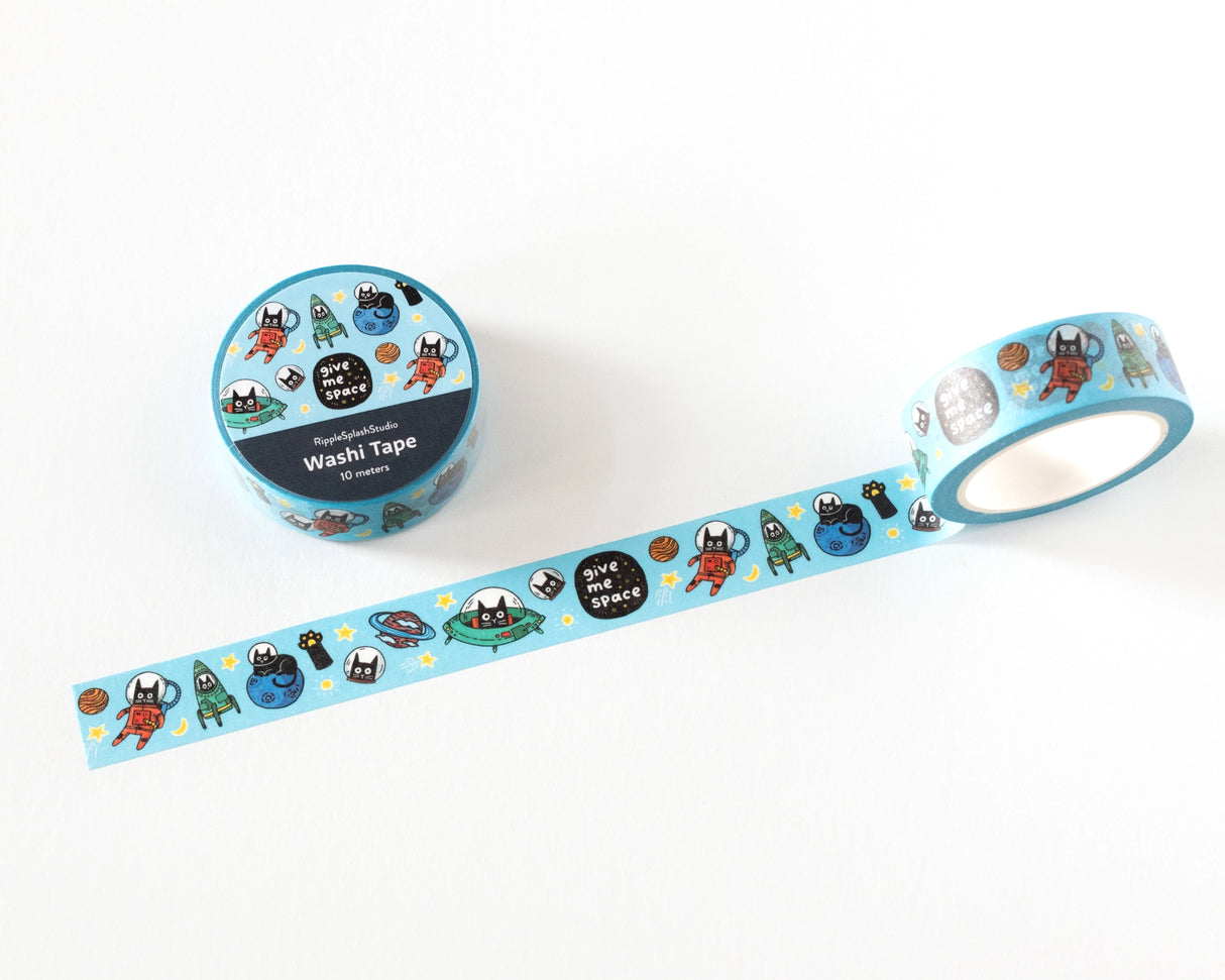 Decorative washi tape featuring playful illustrated cats in space, including astronauts, planets, and stars. Perfect for planners, journals, gift wrapping, scrapbooking, and creative projects. Easy to tear, repositionable, and residue-free.

🌈 Key Features:

Dimensions: 15mm wide x 10 meters (32.8 feet) in length&nbsp;
Contains: 1 washi tape roll

High-quality washi tape material
Easy to tear and reposition
Perfect for scrapbooking, journaling, and crafts