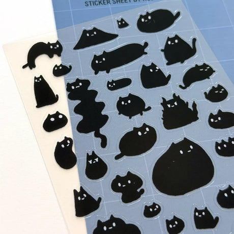 This is part of a new series of sticker sheets that feature different "days".

This one features Sumi the cat on an odd day.

There are 39 individual stickers on the sheet.

They are plastic stickers on a plastic sheet with a backing card and packaging that's ready to display.

The whole packaging is 3.8 x 8.75" and is ready to hang.
The sticker sheet is 3.75 x 5.8"