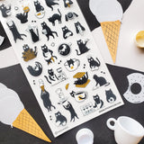 ☕🐈 Chaos is brewing at this tiny cat café! These busy little beans are pouring coffee, stacking waffles, slurping noodles, and sneaking bites between orders. From barista duties to snack-time shenanigans, every kitty is hard at work (or hardly working). Add these mischievous café cats to your pages for a sprinkle of cozy chaos and extra espresso energy.

Top Coating: None
Adhesive Layer: PVC (plastic)
Backing Layer: Clear PET
6.69" x 3.54".
Weight - 0.03lbs.
1 sheet included &nbsp; &nbsp;