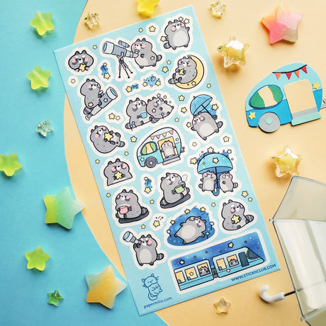 🌟🦝 Adventure calls, and these chonky little stargazers by @papermilio are answering, with snacks packed and eyes on the sky! From peeking through telescopes and wishing on shooting stars to camper trips, and umbrella strolls beneath twinkly skies, these cosmic cuties are following the stars—wherever they may lead.