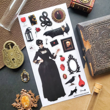 🕯️🦇 Step into a shadowy parlor of vintage gothic charm with this hauntingly elegant sticker sheet. From mysterious masked figures and candlelit curiosities to ravens, roses, serpents, and forbidden tomes, every piece feels plucked from an old-world cabinet of wonders. Perfect for adding a touch of dark romance, eerie beauty, and timeless intrigue to your spreads and creations.