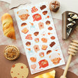 🧺🍯 Pack your blanket for the coziest little picnic! This darling sheet by @yomihonei is filled with flaky croissants, chocolatey buns, chunky cookies, golden loaves, buttery toast, and jars of honey all nestled on a gingham spread. With an adorable bear friend busy filling baskets and tying up tasty treats, it’s a kawaii afternoon of sunshine, crumbs, and cuddly bakery bliss. These stickers will add a drizzle of honeyed happiness wherever you stick them!

Art by: @yomihonei

Top Coating: None
Adhesive Lay