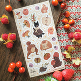 🐹🍎 In @anikeru’s whimsical corner of the woods, autumn’s bounty is gathered by the sweetest of friends. A dapper black cat carries fresh berries, mice and hamsters tuck into plump fruits and seeds, and a toad carries treasures on its back. It’s a season painted in warmth, where every creature has a story to share.