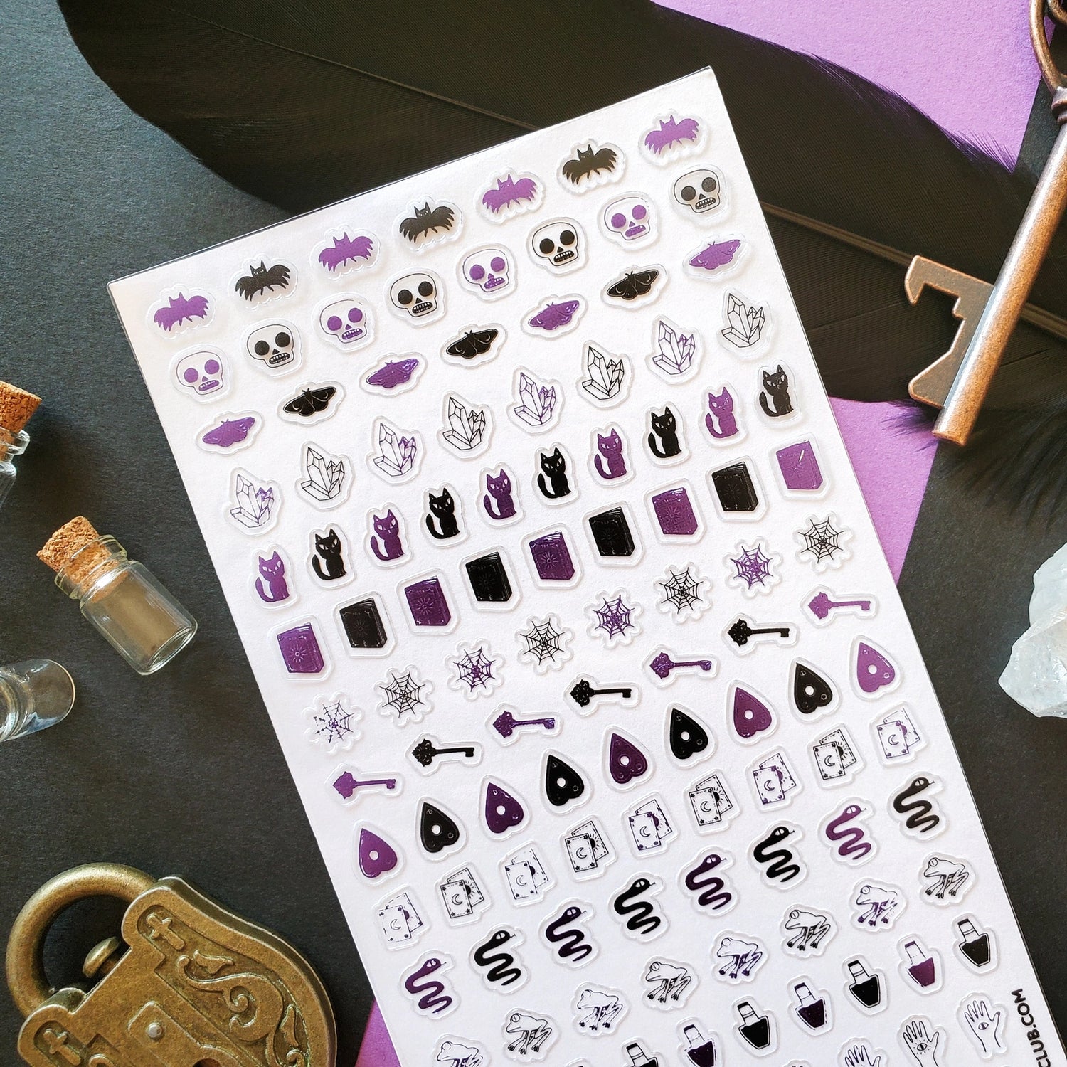 🦇🧪 Double double, foil and trouble—this sticker sheet is a bold and playful spell gone fabulously right! You’ll find crystal shards crackling with energy, wide-eyed black cats casting curious glances, and bubbling potion bottles. Snakes wiggle, frogs leap, and ravens look ready to caw secrets into the night. Tarot cards, witch hats, and keys to hidden realms mix with enchanted hands and mysterious planchettes, all ready for a night of mystical mayhem.