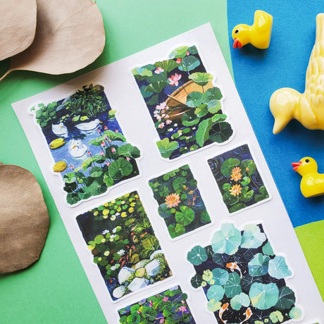 🪷🐟 Pond day? Pond day. @zoe.art.garden brings us the most peaceful little pond. Koi are swimming, ducks are floating, lotus blooms are showing off, and the lily pads are basically VIP lounges for every tiny pondside creature. This sheet is lush, splashy, and wildly dreamy, like you accidentally wandered into this jaw dropping scene and decided, actually, we live here now.

Art by: @zoe.art.garden

• One sticker sheet is included.
• Top Coating: None
• Adhesive Layer: Paper
• Backing Layer: Clear PET
• 6.6