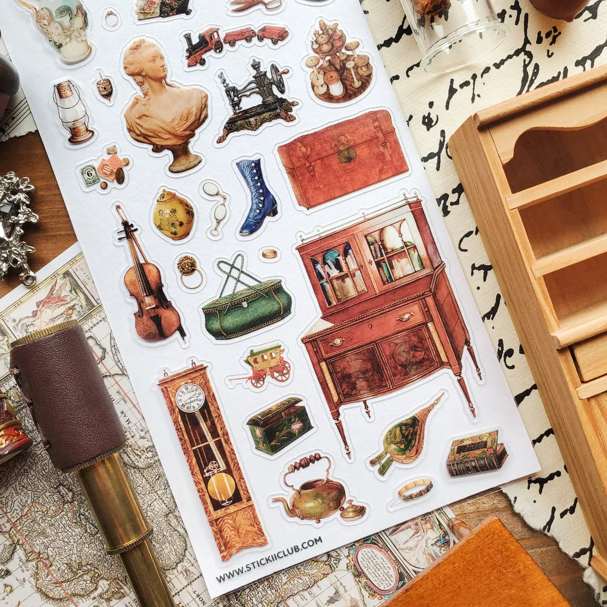 STICKII - Treasured Antiques Sticker Sheet

🕰️🧳 Brimming with timeworn treasures, this sheet feels like a quiet afternoon spent wandering through an antique shop. From ornate clocks and old sewing machines to travel trunks, violins, gramophones, and carefully kept curios, each piece captures the charm of objects with a story to tell. Perfect for adding a little old-world elegance, mystery, and nostalgia to your pages.

Top Coating: None
Adhesive Layer: Paper
Backing Layer: Paper
6.69" x 3.54".
Weight - 0.