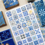 STICKII Azure Whimsy Tiles Sticker Sheet

💙✨ Bring timeless elegance to your creations with this stunning sheet of vintage tiles patterned with intricate designs and shimmering foil accents. From dainty florals to bold geometrics, every square echoes the artistry of classic ceramics in rich shades of blue and gold.