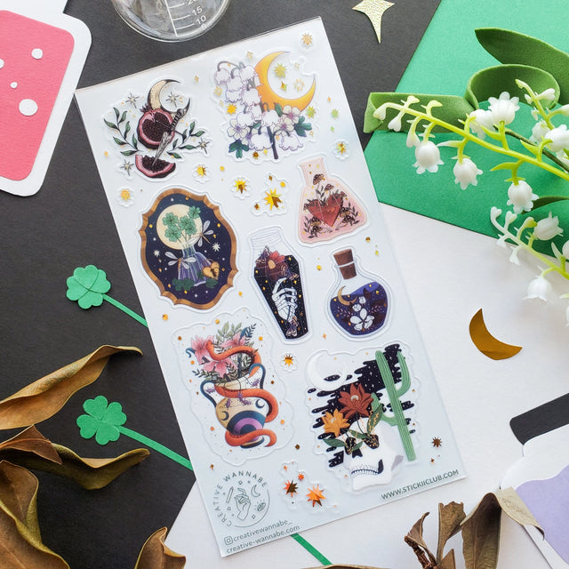 STICKII In the Dead of Night Sticker Sheet A sticker sheet with various designs including a crescent moon, stars, and plants, with a gold foil top coating and clear PET backing.