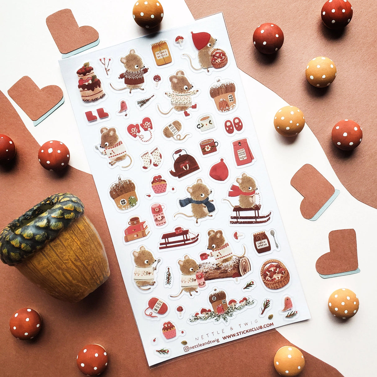 🐭☕️ Cozy up with @nettleandtwig’s snug little mouse village, where winter days are filled with woolly sweaters, steaming cocoa, and muffins fresh from the oven! Among snow-dusted acorn cottages, these tiny friends spend their time sledding, knitting, and sharing warm moments by the fire.

Top Coating: None
Adhesive Layer: PVC (plastic)
Backing Layer: Clear PET
6.69" x 3.54".
Weight - 0.03lbs.
1 sheet included&nbsp;