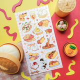 🐶🌭 Puppers meet tasty treats in the most drool-worthy mash-up ever! Whether they’re snoozing in a sandwich bun, rolling around in sushi, or napping in a basket of bread, @yumbrite’s delicious doggies are living their best foodie lives!

Art by: @yumbrite

Top Coating: None
Adhesive Layer: Paper
Backing Layer: Clear PET
6.69" x 3.54".
Weight - 0.03lbs.
1 sheet included&nbsp;