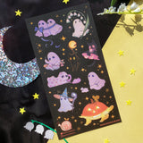 STICKII Starlit Ghosties Sticker Sheet Sheet of Halloween-themed stickers with ghosts, cats, and pumpkins on a black background.