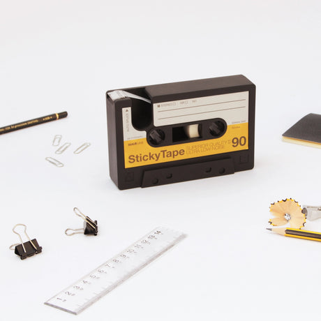 So retro it hurts! Oversize cassette tape reimagined to hold and dispense sticky tape. Made from chunky heavyweight rubber that will grip your desk. Does everything a tape dispenser would normally do, but with buckets of nostalgic charm. A great gift for the old-school music geek in your life.