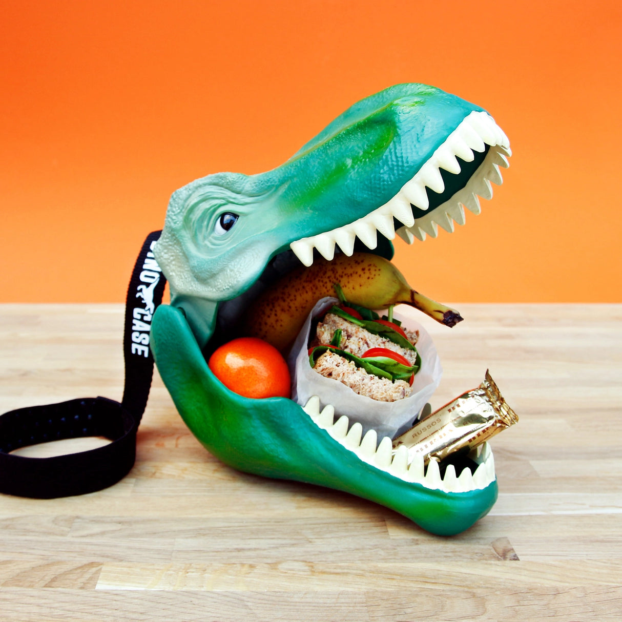 Keep your snacks safe from extinction with this fierce T-Rex head lunchbox. Made from durable polypropylene with a secure silicone lining and a sturdy fabric carry handle, it’s tough enough for any Jurassic adventure. Big enough for sandwiches, fruit, and treats — or for storing toys, crayons, or fossils — this versatile case is perfect for school, play, or travel.
