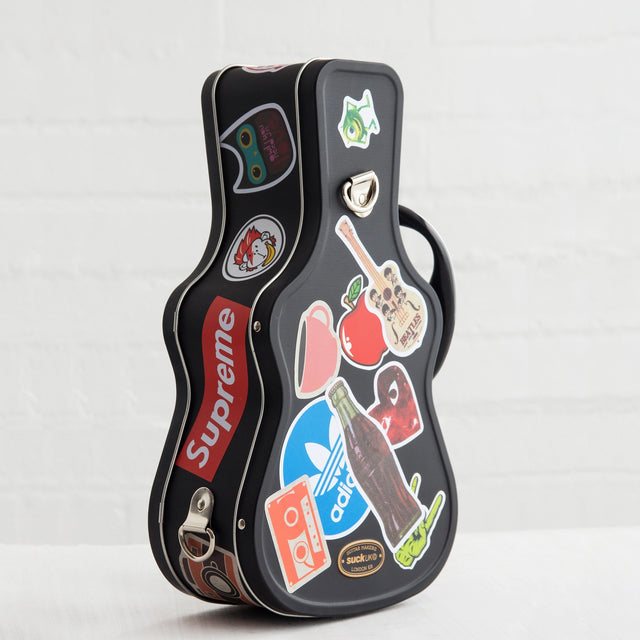 Lunch just got loud. This guitar-shaped tin lunchbox brings rock-n-roll attitude to school, work, or picnics. Keep sandwiches and snacks secure with a sturdy latch and carry handle, then personalise your case with the included set of stickers – just like a real tour pro. Made from durable, food-grade tin and designed to last, it’s the coolest way to carry your lunch on the road.