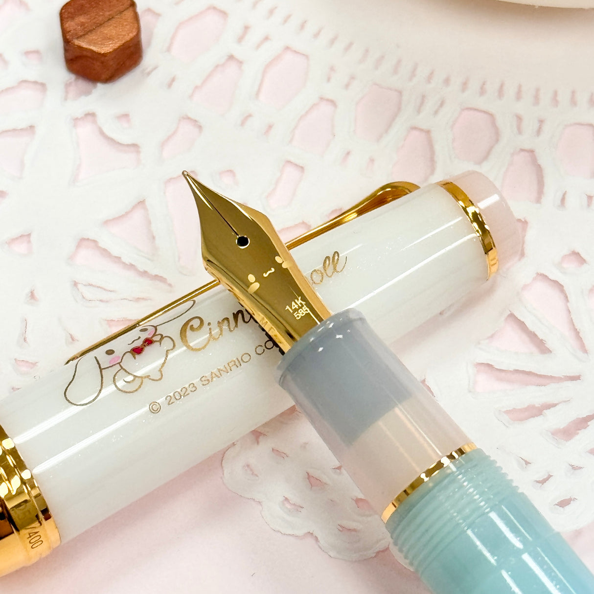 Sailor Limited Edition Professional Gear Slim Fountain Pen - Cinnamoroll

Discover a charming collaboration between Sailor Fountain Pen and Sanrio’s beloved character, Cinnamoroll! This limited-edition fountain pen captures the elegant and adorable world of Cinnamoroll, featuring luxurious gold accents on the clip and ring, along with special Cinnamoroll logo motifs on the cap, finial, and nib. The 14k gold nib is beautifully engraved with Cinnamoroll’s face, adding a delightful touch to this unique wr