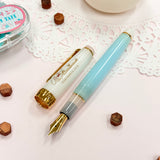 Sailor Limited Edition Professional Gear Slim Fountain Pen - Cinnamoroll

Discover a charming collaboration between Sailor Fountain Pen and Sanrio’s beloved character, Cinnamoroll! This limited-edition fountain pen captures the elegant and adorable world of Cinnamoroll, featuring luxurious gold accents on the clip and ring, along with special Cinnamoroll logo motifs on the cap, finial, and nib. The 14k gold nib is beautifully engraved with Cinnamoroll’s face, adding a delightful touch to this unique wr