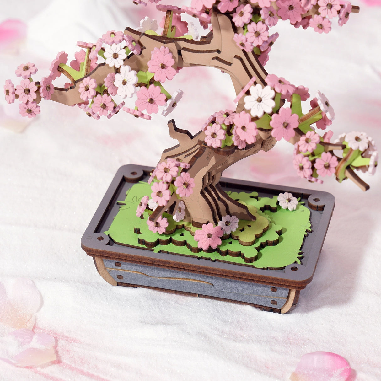 Bring the serene beauty of nature into your home with this captivating DIY 3D wooden puzzle kit, featuring a delicate cherry blossom bonsai tree. This enchanting puzzle lets you craft a stunning, intricate tree adorned with blooming cherry blossoms, all from precision-cut wooden pieces that fit together seamlessly. Perfect for displaying in your home or office, this elegant puzzle serves as a reminder of the peaceful beauty of cherry blossoms in bloom.