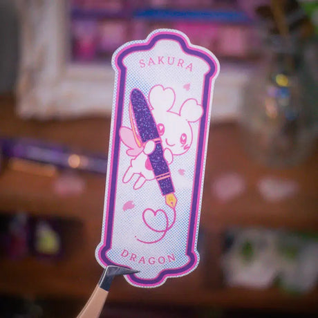 Sakuradragon loves the Esterbrook x Sakuradragon Sakura Street Fountain Pen.

This is a vinyl sticker and measures about 3 inches tall and is waterproof, dishwasher safe, scratch resistant, and UV-resistant.

Dimension: 3.64in x 1.46in