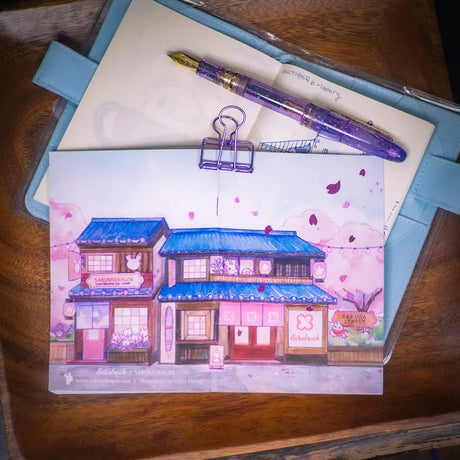 Sakuradragon - Sakura Street Shopfronts Postcard

A souvenier to send your friends from Sakura Street!

4x6" illustration postcard printed on 15pt card stock paper.
Satin matte finish.
