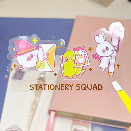 Cartoon character bookmarks with 'Stationery Squad' branding on a notebook.