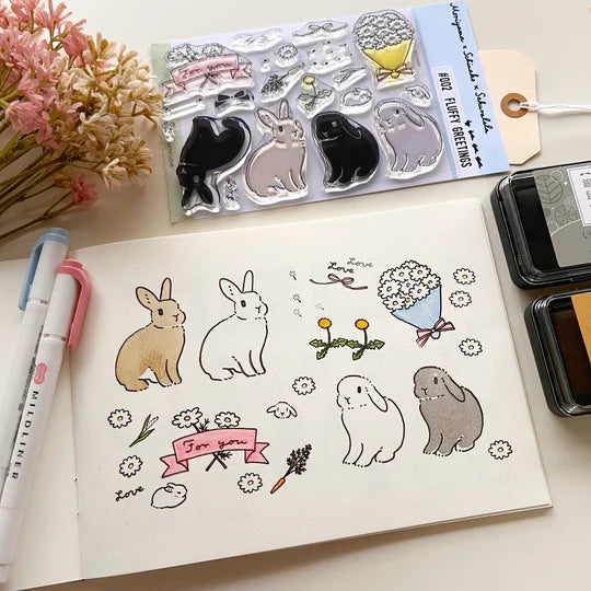 This collaboration with Moriyama, who has a wonderful shop in Ota Ward, Tokyo, and Shiko Moriyama, an illustrator who draws adorable rabbits.

"Fluffy Greetings" is a clear stamp that allows you to make rabbit cards. Since it is a large stamp, it can be printed in a notebook or journal as a cute accent. The stamps of the two large rabbits are divided into a base outline stamp and a coloring stamp that serves as a pattern.