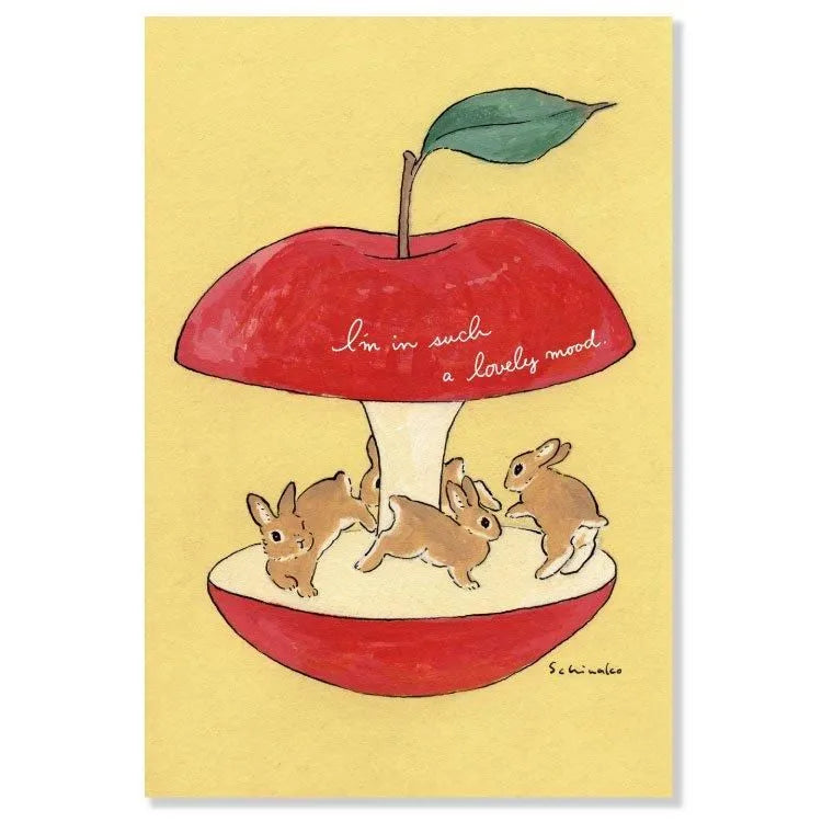 Join the fun with this postcard by Schinako Moriyama! This postcard features bunnies circling in an apple with the message "I'm in such a lovely mood".

4in x 5.8in