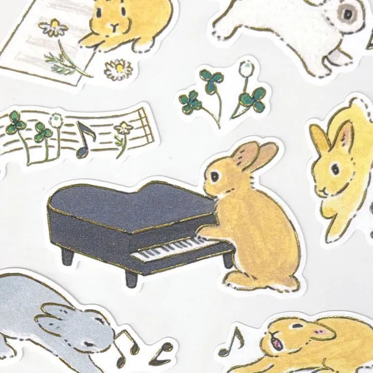 Schinako Moriyama Rabbits and Music Sticker Sheet

A sticker sheet with gold outlines featuring rabbits playing various instruments to showcase musical talents is here to add both adorable and elegant touches to your journal pages ♪