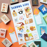 ✏️📖 School is in session, and @mochigardens’ adorable little students are doing their very best… mostly! From acing tests and hauling backpacks to sneaking snacks, falling asleep on textbooks, and tackling some seriously confusing homework, these studious critters know that school life is a mix of hard work and tiny treats. Art by: @mochigardens

Top Coating: None
Adhesive Layer: PVC (plastic)
Backing Layer: Clear PET
6.69" x 3.54".
Weight - 0.03lbs
1 sheet included